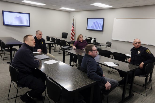 In this file photo Shana Krogmeier, the director of Des Moines County's emergency communications service, DesCom, center, meets with advisory board members from left Burlington Fire Department Chief Matt Trexel, West Burlington Police Chief Jesse Logan, Danville Fire Department Assistant Chief Allen Schillie and Burlington Police Chief Dennis Kramer, Thursday Feb. 21, 2019 at the Burlington Police Station.  