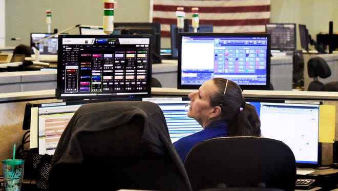 In this file photo, an employee talks with a co-worker at the York County 911 Center Monday, July 31, 2017.