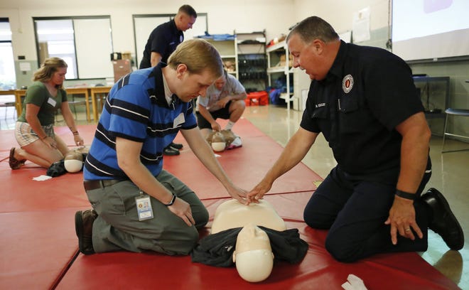 Dispatchers often coach bystanders by phone to help save people's lives, but it's great if they already know CPR. In this file photo, EMS instructor Robert Kelley helps Robert Ford, 31, of Galloway, with hand placement for chest compressions during a CPR class at the Columbus Fire Training Academy on the South Side.