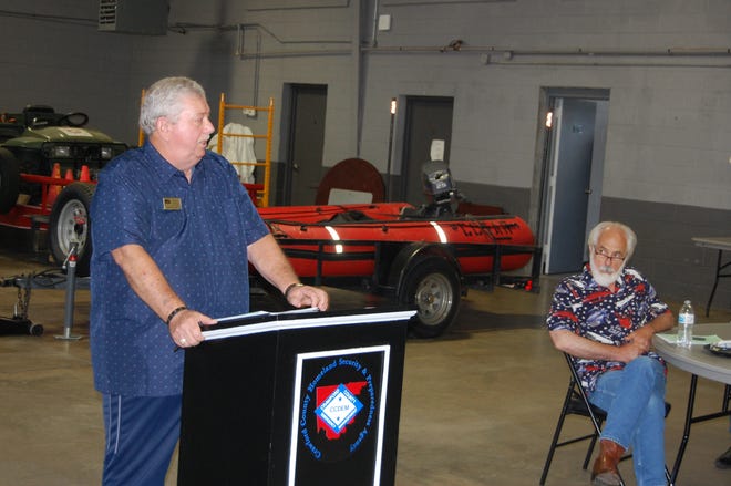 Kibler Mayor Gary O'Kelley, right, listens as Crawford County Judge Dennis Gilstrap discusses the new budget for the county's consolidated 911 service during the Intergovernmental Council meeting held July 13 in Van Buren.