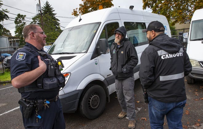 Eugene police officer Bo Rankin, from left, meets with CAHOOTS Administrative Coordinator Ben Brubaker and emergency crisis worker Matt Eads after working a shift together as part of the Community Outreach Response Team in Eugene.