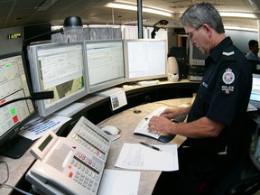 Sgt. Guy Kinney, a 911 dispatcher, works at the 911 dispatch centre at EPS Headquarters downtown Wednesday. Media was invited for a tour to inform the public about the "Curb the Danger" program.