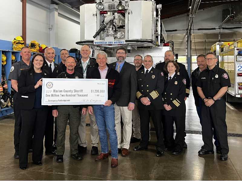 COURTESY PHOTO: WOODBURN FIRE DISTRICT - Congressman Kurt Schrader joins a variety of public safety and Marion County officials on May 6 to formally present $1.2 million in federal funds that will be used to improve public safety communications countywide.